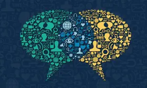 Deux bulles de dialogue composées d'icônes symbolisant la communication et les réseaux sociaux, illustrant la tendance réseaux sociaux.